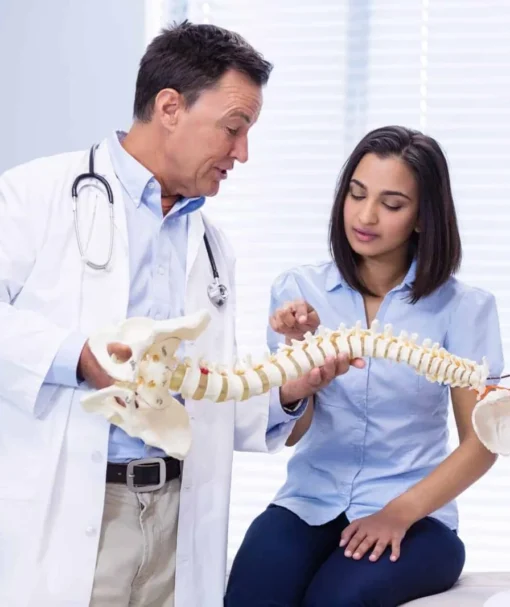 physiotherapist-explaining-spine-model-to-patient